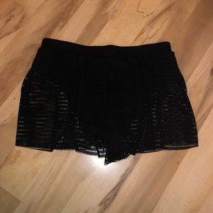 Black swimsuit bottom with mesh shorts coverup